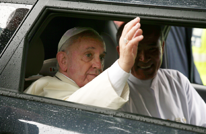 프란치스코 교황이 18일 명동성당에서 열린 ‘평화와 화해를 위한 미사’에 참석하기 위해 차량으로 이동도중 환영하는 인파들을 향해 손을 흔들고 있다. 