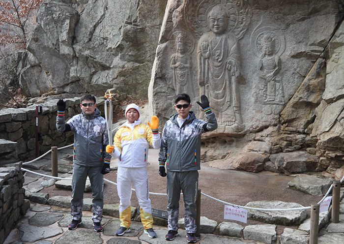 7일 충청남도 서산시 운산면 마애여래삼존불 앞에 도착한 성화봉송주자가 기념촬영을 하고 있다.