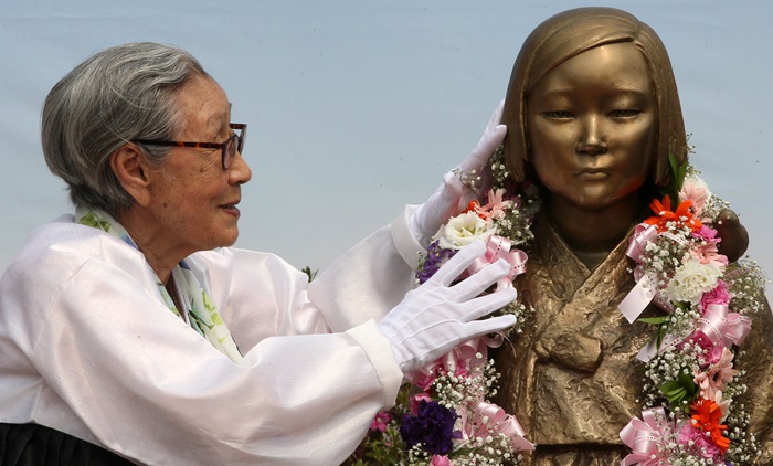 Kim Bok-dong streichelt die Mädchenstatue, die die Hoffnung für diese Frauen sowie die Opfer der sexuellen Gewalt symbolisiert. ⓒ Yonhap News