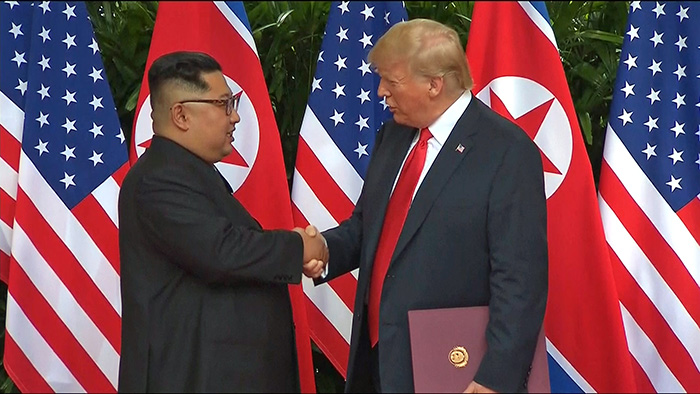 Nach der Vertragsunterzeichnung geben sich Nordkoreas Vorsitzender Kim Jong Un und US-Präsident Donald Trump am 12. Juni im Capella Hotel auf der Insel Sentosa in Singapur die Hände. ⓒ Yonhap News