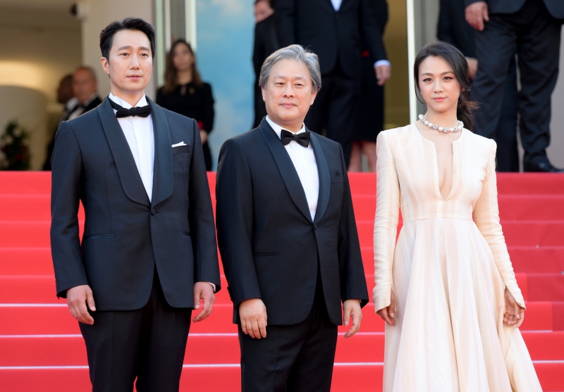 CJ ENM Regisseur Park Chan-wook (Mitte) und die Schauspieler Park Hae-il (links) und die chinesische Star Tang Wei treten am 23. Mai auf dem roten Teppich der 75. Filmfestspiele von Cannes auf. ⓒ CJ ENM