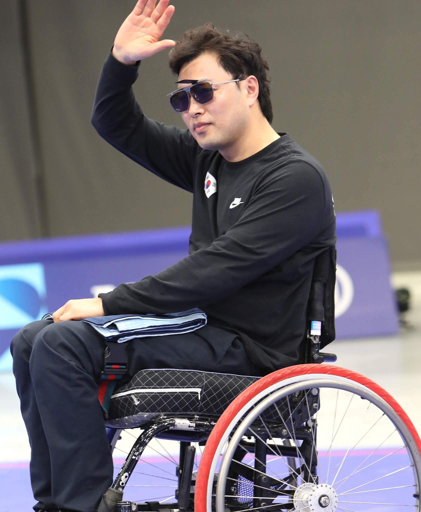 Der koreanische Schütze Kim Jungnam winkt am 2. September zu, nachdem er am selben Tag bei den Paralympischen Spielen 2024 in Paris im Mixed-25m-Pistole in der Klasse SH1 im Chateauroux Shooting Centre die Bronzemedaille gewann.