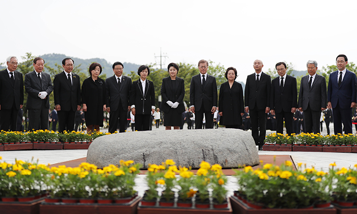 문재인 대통령(오른쪽 여섯 번째)과 김정숙 여사(가운데), 권양숙 여사(오른쪽 다섯 번째) 등 참석자들이 23일 경남 김해시 진영읍 봉하마을 묘역에서 열린 노무현 전(前) 대통령 서거 8주기 추도식에서 묵념하고 있다.