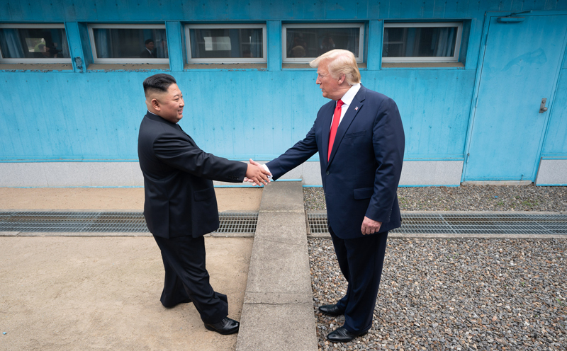 US-Präsident Donald Trump und Nordkoreas Vorsitzender Kim Jong-un schütteln sich über der militärischen Demarkationslinie (MDL) die Hände, wie die Staatschefs von Süd- und Nordkorea am 27. April 2018 gemacht hatten. ⓒ Weißes Haus