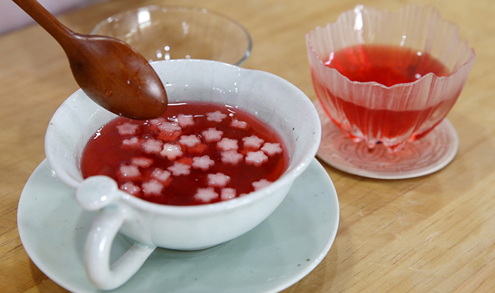 Serve the punch in a bowl with pear and pine nuts as decoration.