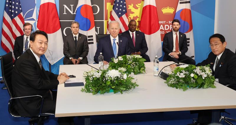 Präsident Yoon Suk Yeol (links), US-Präsident Joe Biden (Mitte) und dem japanischen Premierminister Fumio Kishida kommen am 29. Juni 2022 am Rande eines NATO-Treffens im IFEMA-Kongresszentrum in Madrid zu einem Dreiertreffen zusammen.