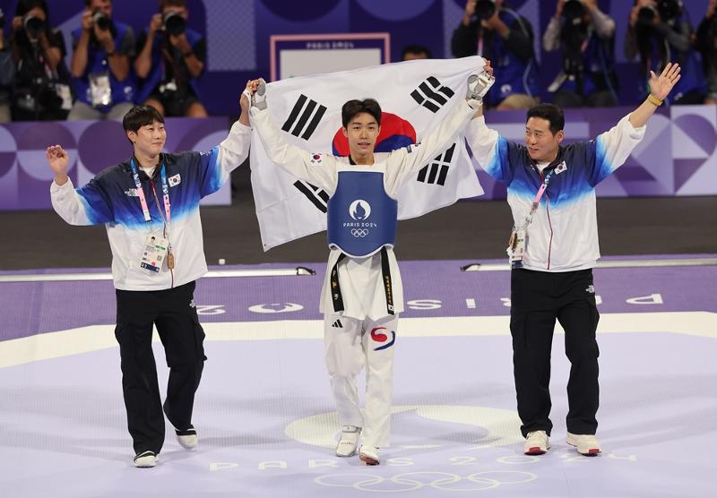 Park Taejoon, koreanischer Athlet (Mitte), freut sich am 7. August bei den Olympischen Sommerspielen 2024 in Paris über seinen Sieg im Taekwondo-Finale der Männer bis 58 kg im Grand Palais. 