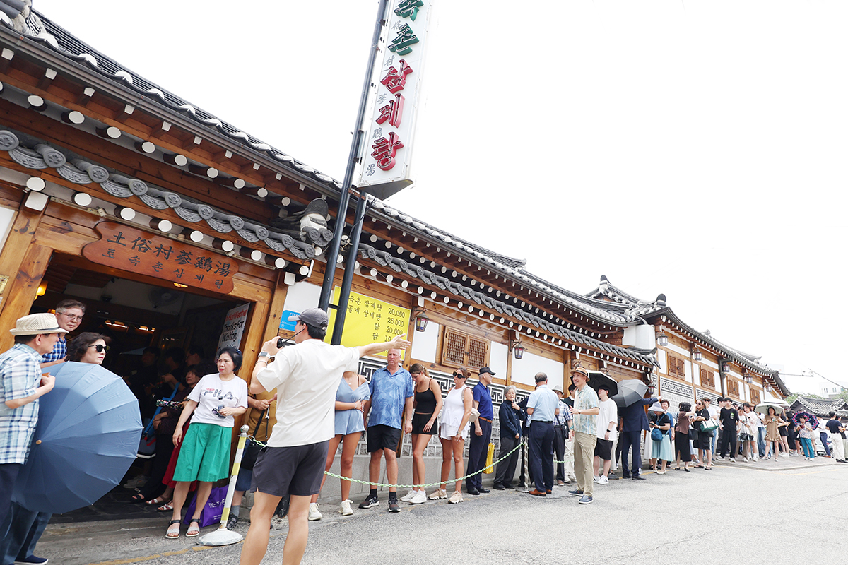 Am 30. Juli, Jungbok, dem Beginn des mittleren Abschnitts der heißesten Sommertage, stehen Menschen vor einem Samgyetang-Restaurant in Jongno-gu, Seoul, in der Schlange. In Korea wird an Jungbok Samgyetang, Hühnersuppe mit Ginseng, gegessen, um sich von der Hitze zu erholen.